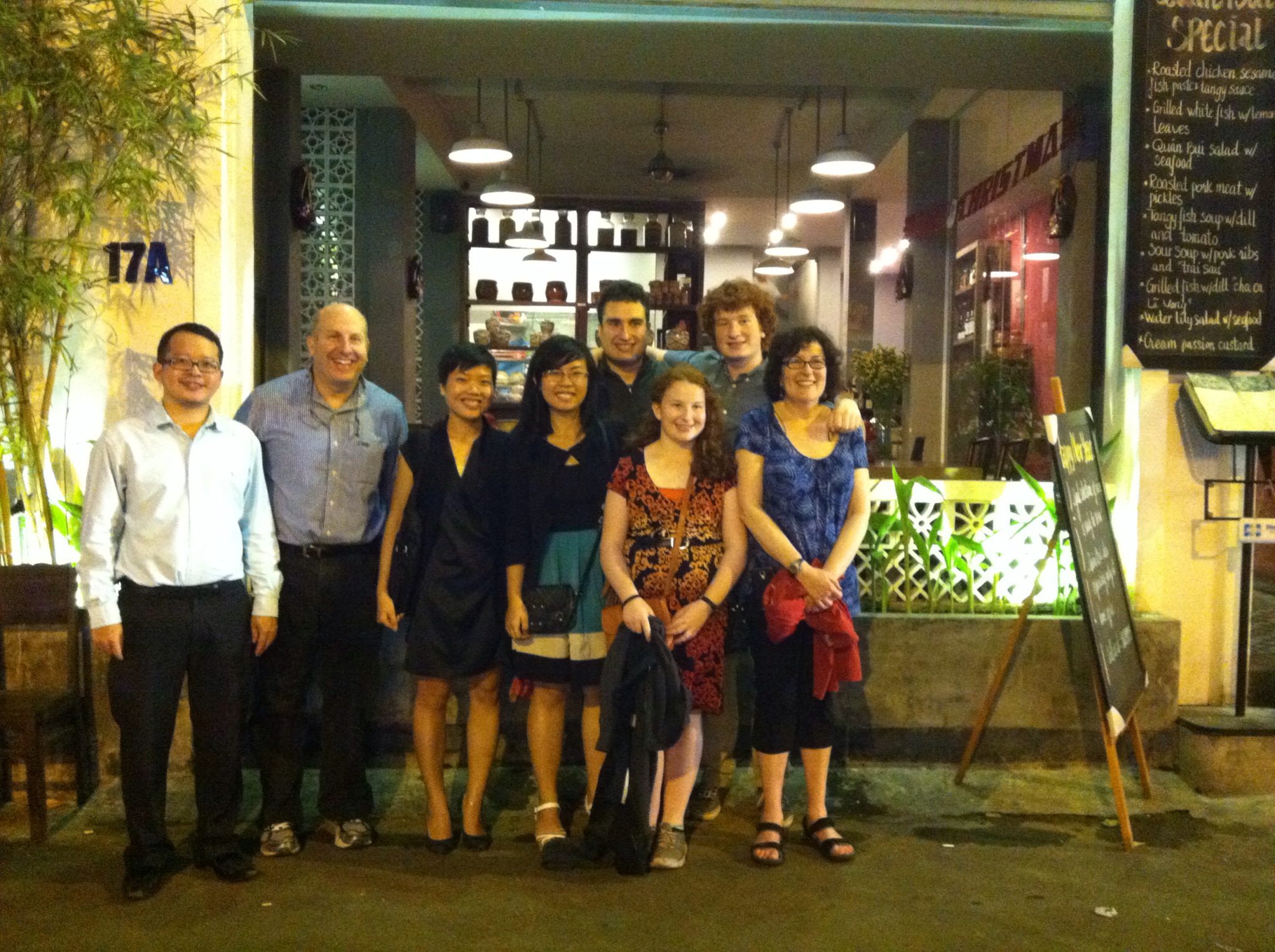 A group including President Krislov outside a restaurant